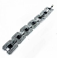 Full view of the vintage rhinestone bracelet laid flat, showing the linked rectangular segments with clear and black rhinestones.