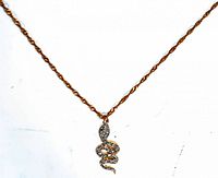 Full necklace view showing gold-tone twisted chain and rhinestone snake pendant.