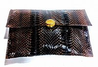 Full view of the brown vintage snakeskin clutch purse showing its rectangular shape and flap closure.