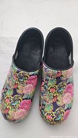 Top down view of the floral clogs showing colorful pattern and overall condition.