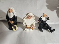 Three Heavenly Habits nuns figurines showing different poses and items