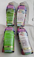 Four sealed OGX bottles, two Tea Tree Mint and two Coconut Miracle Oil, two shampoos and two conditioners.
