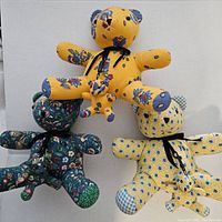 Three Vera Bradley bears showing different fabric patterns and overall condition