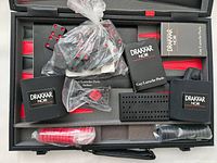Photo showing all accessories and components including dice, checkers in bag, dice cups, dice holder, and booklets in the case
