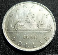 Reverse of 1936 Canadian silver dollar with canoe scene and date.