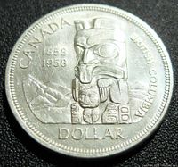 Close-up of the reverse side of the 1958 Canada silver dollar showing the totem pole design and inscriptions.