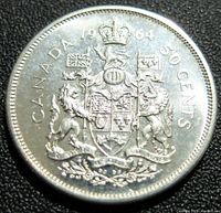 Close-up image of the reverse side of the 1964 Canadian silver 50 cents coin showing the Canadian coat of arms with the date 1964, 'CANADA', and '50 CENTS' engraved.