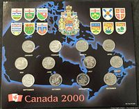 Full set of twelve Canada 2000 commemorative 25 cent coins displayed on a black card with Canadian provincial crests and month labels beneath each coin.