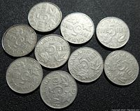 Top view of the reverse sides of ten silver Canadian 5 cents coins, showing maple leaf design and year dates 1922 to 1936 range.