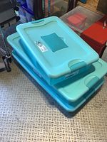 Three light teal Sterilite Fresh Scent under bed storage boxes stacked, showing lids.