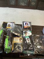 Photo shows seven packages of hair extensions on a table, each labeled with different styles such as Jamaican Bounce, Wand Curl, FreeTress, and Mgire-Daniele.