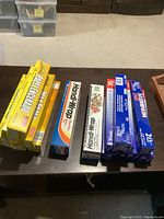 Photo showing all foil wrap, cling wrap, and wax paper rolls on a table