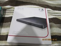 Photo of the LG Ultra Slim Portable DVD Writer box showing front with branding and product name