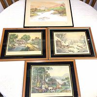 Five framed prints arranged on a table showing various outdoor scenes including hunting, fishing, and winter morning.
