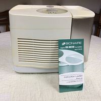Front and side view of Bionaire humidifier with instruction leaflet displayed in front.