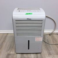 Front view showing white Danby Premiere dehumidifier with water collection tank and air intake vents.