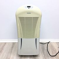 Front view of beige and light gray Danby Simplicity dehumidifier showing front grille, control panel, and power cord.