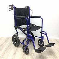 Three-quarter right front view showing frame, seat, hand brakes, footrests