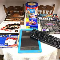 Overview of the game collection including the keyboards, Cranium, Risk, Mah Jongg, Roulette, In Pursuit, and Cracker Jack popcorn tin