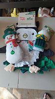 Overview photo of cat toys including snowman, coffee mug, and penguin snuffle mat with packaging