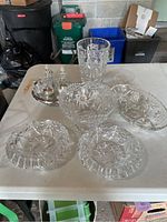 All items displayed on a table including the cruet set, vase, bowls, and ashtrays showing cut crystal details.