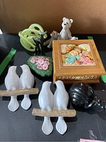 Overview photo of lot showing bird statuettes, bear and deer figurines, music box, painted rock, and snail figurine.