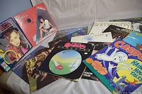 Photo showing multiple vintage vinyl record covers spread on surface, including Culture Club, Sheena Easton, Casper, Heart, and more.