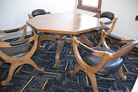 Octagonal dining table surrounded by four chairs