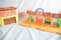 Fire station and fold-out building in bright light showing colors and structure