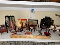Overview of miniature Asian-themed dollhouse furniture including chairs, tables, folding screens, decorative jars, and cushions, with a wooden ruler for scale showing sizes from 0.5 to 7 inches.