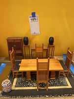 Overview of table, chairs, cabinet, console, plant stands, and rug