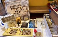 Full overview shot of the entire lot showing miniature lamps, bulbs, instruction board, wiring, and smaller boxed components laid out on a table.