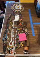 Photo of multiple Southwestern beaded jewelry items on a table showing diverse patterns and shapes.