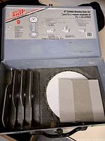 Open view of original carrying case foam with 8 blades and 2 paper washers arranged neatly inside.