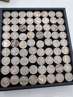 Full view of all Buffalo Nickel coins arranged on black tray showing front obverse sides with Native American profile.