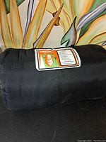 Norseman sleeping bag rolled up with brand patch visible