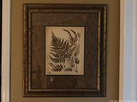 Full view of framed botanical art print showing fern leaves with a brown textured frame.