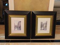 Two framed black and white Venice canal prints side by side showing overall condition and size.