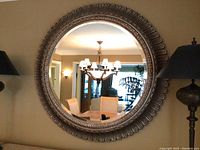 Front view of entire circular mirror hanging on wall