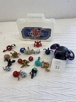 Photo of all Bakugan figures outside carrying case showing various colors and designs including one large figure.