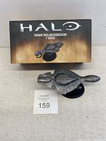 The boxed Halo Covenant Truth and Reconciliation 7 inch replica with display stand shown in front of the box.