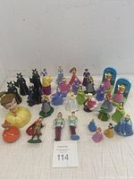 24 assorted used McDonald's Disney Happy Meal figurines displayed together showing variety of princesses, princes, queens, step sisters, and characters from Disney stories.