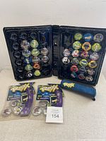 Collector's case open showing 38 colorful ROXX discs with various designs in molded slots. Some corner damage visible.