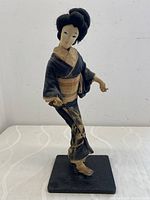 Front view of the vintage handmade fabric Geisha doll showing its detailed clothing and face.