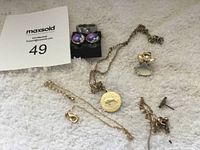 Photo showing all jewelry items including ring, earrings, necklaces, and angel pendant.