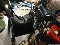 Photo of the four wheel walker with seat and the manual wheelchair showing overall condition and details.