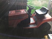 Side view showing seat, deck, and rear wheels