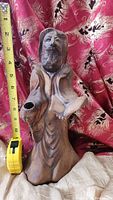 Full view of the pottery monk/priest statue with a measuring tape showing height about 7 inches.