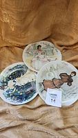 Photo of the set of three Limoges decorative plates depicting women in period costumes