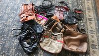 Overview of the 11 vintage purses and handbags arranged on a patterned rug showcasing a variety of colors, materials, and styles.